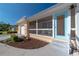 Side view of a house with light blue door, screened porch, and landscaped yard at 3873 21St N Ave, St Petersburg, FL 33713