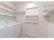 Laundry room with washer, dryer and shelving at 3873 21St N Ave, St Petersburg, FL 33713