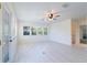 Bright living room features a ceiling fan, large windows, and light-colored floors at 3873 21St N Ave, St Petersburg, FL 33713