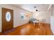 Cozy living room featuring hardwood floors, ceiling fan, large windows, and a welcoming entryway with a wooden door at 3873 21St N Ave, St Petersburg, FL 33713