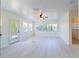 Bright, spacious living space with light-colored flooring, fan, lots of windows, a doorway, and modern lighting at 3873 21St N Ave, St Petersburg, FL 33713