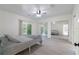 Bright primary bedroom with modern flooring, ceiling fan, closet with mirrored doors, and sliding door access to outside at 3873 21St N Ave, St Petersburg, FL 33713