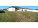 Large backyard with grassy area and patio at 39822 Harmon Grove Ct, Zephyrhills, FL 33540