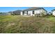 Backyard with grassy area and small patio at 39822 Harmon Grove Ct, Zephyrhills, FL 33540