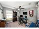 Bright home office features built-in shelving and a large window at 39822 Harmon Grove Ct, Zephyrhills, FL 33540