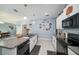 Modern kitchen with white cabinets, granite countertops, and stainless steel appliances at 39822 Harmon Grove Ct, Zephyrhills, FL 33540