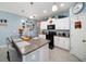 Modern kitchen with white cabinets, granite countertops, and stainless steel appliances at 39822 Harmon Grove Ct, Zephyrhills, FL 33540