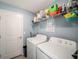 Laundry room offers shelving and space for a washer and dryer at 39822 Harmon Grove Ct, Zephyrhills, FL 33540