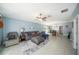 Living room with gray sectional and tile floors at 39822 Harmon Grove Ct, Zephyrhills, FL 33540