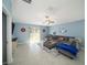 Spacious living room with sectional sofa and tile floors at 39822 Harmon Grove Ct, Zephyrhills, FL 33540