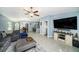 Open concept living area with a gray sectional sofa at 39822 Harmon Grove Ct, Zephyrhills, FL 33540