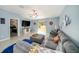 Open concept living room with gray sectional sofa at 39822 Harmon Grove Ct, Zephyrhills, FL 33540