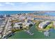 Aerial view of condominium complex near a waterfront neighborhood and beach at 399 150Th Ave # A203, Madeira Beach, FL 33708