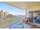 Relax on this condo balcony with comfortable seating and panoramic water views at 399 150Th Ave # A203, Madeira Beach, FL 33708