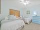 Cozy bedroom featuring a double bed, a beachy color scheme, and a bright window at 399 150Th Ave # A203, Madeira Beach, FL 33708