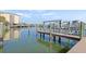 Scenic boat dock featuring lifts and views of the marina and residential buildings on a sunny day at 399 150Th Ave # A203, Madeira Beach, FL 33708