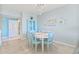 Coastal-themed dining area featuring a glass cabinet, beach decor, and views of the living area at 399 150Th Ave # A203, Madeira Beach, FL 33708