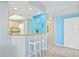 Bright kitchen pass-through with granite countertops, white cabinets, a breakfast bar, and pendant lighting at 399 150Th Ave # A203, Madeira Beach, FL 33708