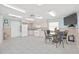 Bright eat-in kitchen with white appliances, tile backsplash, and a dining table for casual meals at 399 150Th Ave # A203, Madeira Beach, FL 33708