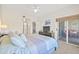 Spacious bedroom with sliding glass doors to a private balcony and en-suite bath at 399 150Th Ave # A203, Madeira Beach, FL 33708