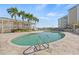 Outdoor pool with comfortable seating and a building with lounge area at 399 150Th Ave # A203, Madeira Beach, FL 33708
