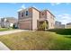 Two-story house with a two-car garage and landscaped yard at 5484 Warrington Town Path, Wesley Chapel, FL 33545