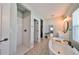 Spa-like bathroom featuring a walk-in shower, freestanding tub, and patterned floor tiles at 7124 Estero Ct, Apollo Beach, FL 33572