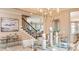 Elegant dining room with a large table, chandelier, and adjacent staircase at 719 Sky Shade Dr, Apollo Beach, FL 33572
