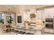 Modern kitchen with white cabinets, granite countertops, and an island at 719 Sky Shade Dr, Apollo Beach, FL 33572