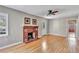 Spacious living room featuring hardwood floors, a fireplace and access to kitchen at 11708 Forest Hills Dr, Tampa, FL 33612