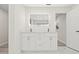 Double vanity bathroom with white cabinets and quartz countertops at 2151 Orangeside Rd, Palm Harbor, FL 34683