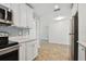 Modern kitchen with white cabinets, stainless steel appliances, and gray backsplash at 2219 13Th Sw Ave, Largo, FL 33770