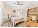 Well-lit bedroom featuring a bed, desk and chair, and wood-look flooring at 24034 Geese Cir, Land O Lakes, FL 34639