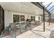 Covered patio featuring neutral furniture, a grill, and sliding door access to the home at 24034 Geese Cir, Land O Lakes, FL 34639