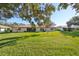 House with a large backyard and green grass at 2414 Locksley St, Sun City Center, FL 33573