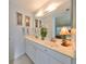 Double vanity bathroom with marble countertop and a shower at 2414 Locksley St, Sun City Center, FL 33573