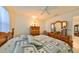 Bedroom with carpeted floor, ceiling fan and wooden dresser at 2414 Locksley St, Sun City Center, FL 33573