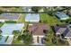 Real estate aerial view showcasing the property within its neighborhood context, including nearby homes, streets, and landscaping at 29417 Caddyshack Ln, San Antonio, FL 33576