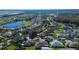 Aerial view of a large community with many houses and a lake at 29417 Caddyshack Ln, San Antonio, FL 33576