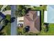 Aerial view showcasing the home's roof, driveway, landscaping, and proximity to surrounding streets and neighboring houses at 29417 Caddyshack Ln, San Antonio, FL 33576