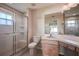 Bright bathroom featuring a glass-enclosed shower, vanity, and modern fixtures at 29417 Caddyshack Ln, San Antonio, FL 33576