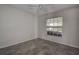 Bright bedroom featuring tile floors, ceiling fan, and a large window at 29417 Caddyshack Ln, San Antonio, FL 33576