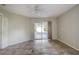 Bedroom featuring tile floors, ceiling fan, and sliding glass door to the outside patio at 29417 Caddyshack Ln, San Antonio, FL 33576