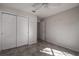 Neutral bedroom featuring tile floors, double closets, and ample natural light at 29417 Caddyshack Ln, San Antonio, FL 33576