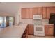 Bright kitchen, featuring wood cabinets, stainless steel appliances, and ample counter space at 29417 Caddyshack Ln, San Antonio, FL 33576