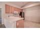Galley style kitchen with light wood cabinets and appliances at 29417 Caddyshack Ln, San Antonio, FL 33576