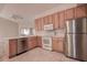 Kitchen with stainless steel appliances and light wood cabinets at 29417 Caddyshack Ln, San Antonio, FL 33576