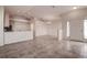 Open-concept living room with tile flooring, chandelier, and view of the kitchen at 29417 Caddyshack Ln, San Antonio, FL 33576