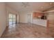 Open-concept living area with kitchen and access to patio at 29417 Caddyshack Ln, San Antonio, FL 33576