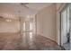 Spacious living room with tile flooring, ceiling fan and sliding glass door to the outside at 29417 Caddyshack Ln, San Antonio, FL 33576